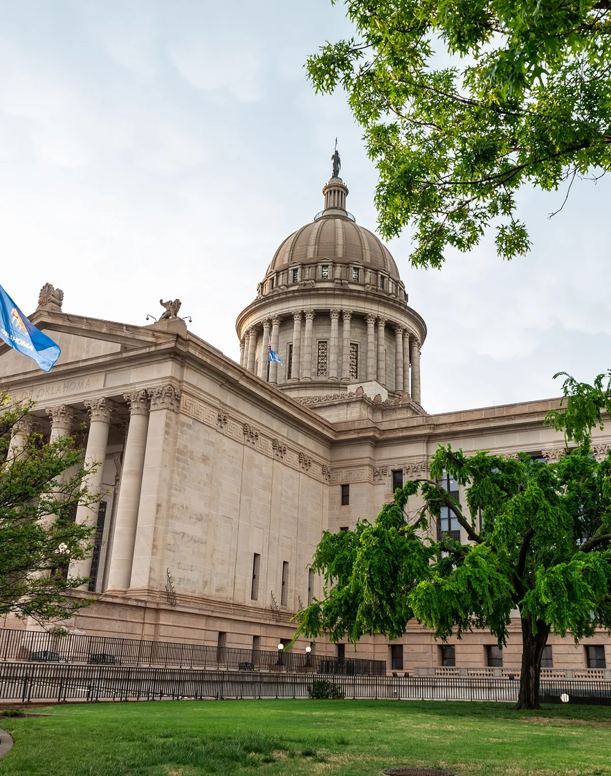 The dome of the Oklahoma State Capitol in Oklahoma City with the Oklahoma flag flying